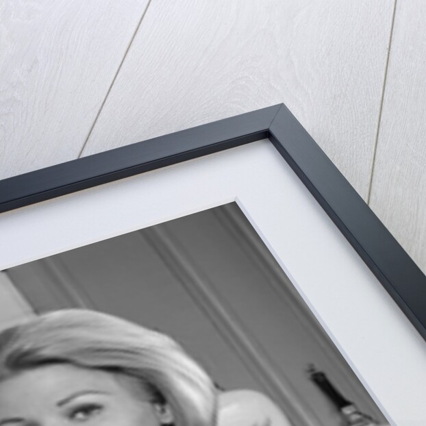 1960s 1970s smiling blond housewife in kitchen holding mixing bowl by Anonymous