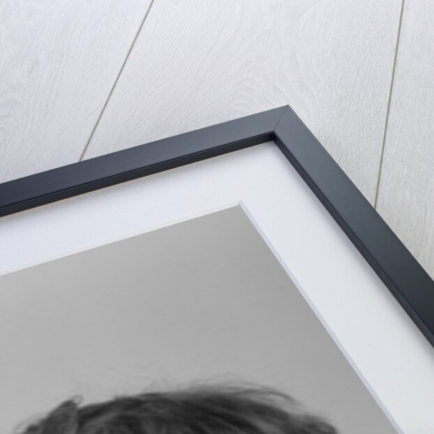 1940s young girl leaning on table staring at hourglass by Anonymous