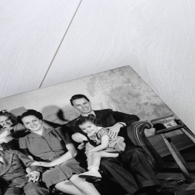1930s 1940s family of five on a couch by Anonymous