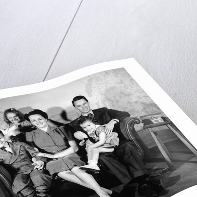 1930s 1940s family of five on a couch by Anonymous