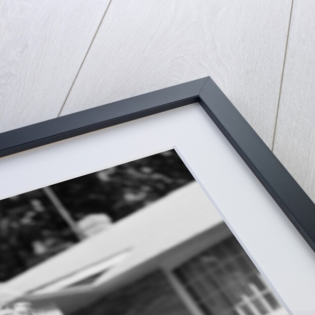 1950s girl on suburban sidewalk playing with a hula hoop by Anonymous