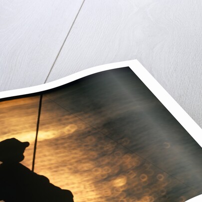 Silhouette of child fishing off a dock at sunset by Anonymous