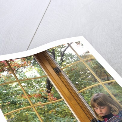 Little girl reading at home by Anonymous