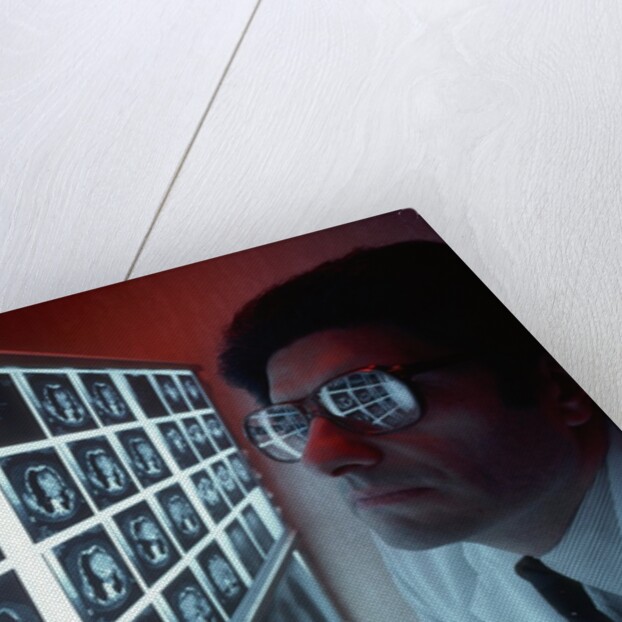1980s doctor examining CAT scan by Anonymous