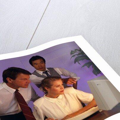 Business people working together at desktop computer by Anonymous
