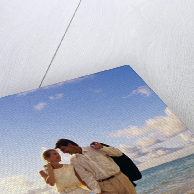 1980s 1990s couple walking on beach by Anonymous