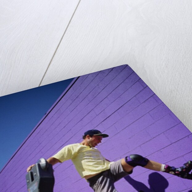 Boy Wearing Roller Blades Jumping Against Wall by Anonymous