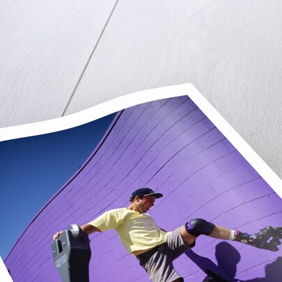 Boy Wearing Roller Blades Jumping Against Wall by Anonymous