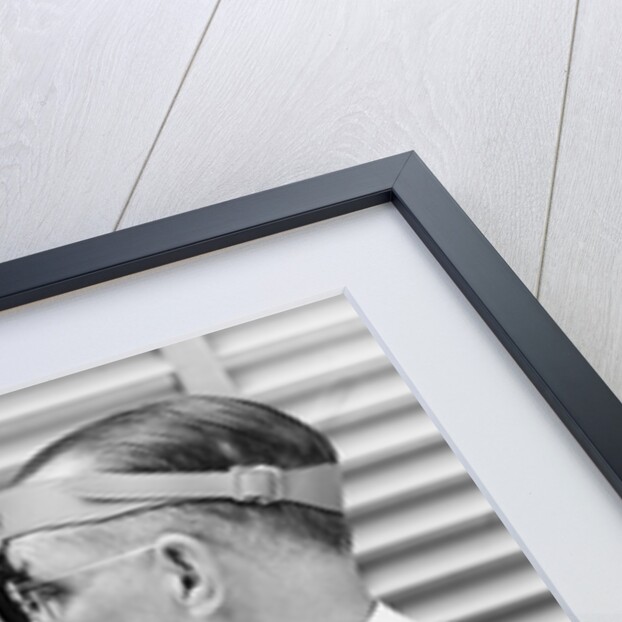 1930s 1940s doctor examining throat of a young man by Anonymous