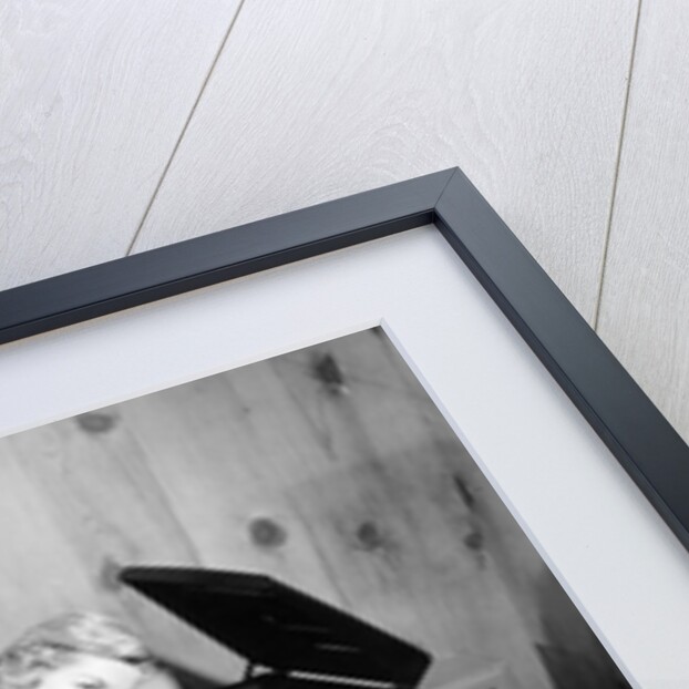 1950s teenage girl listening to music on a phonograph by Anonymous