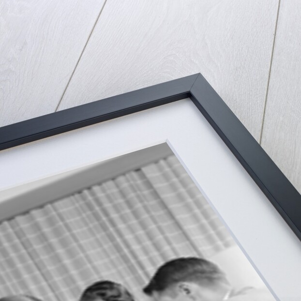 1950s group of businessmen looking at a blueprint on a table by Anonymous