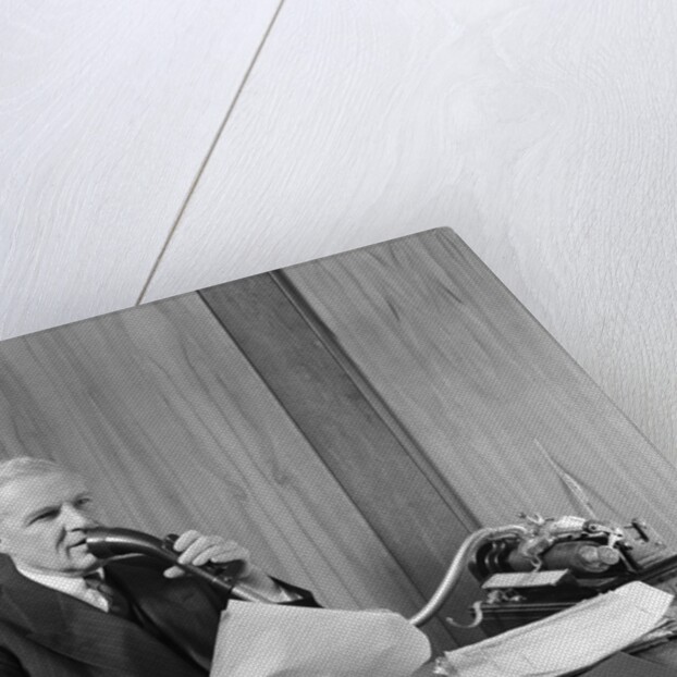 1930s senior executive speaking into a dictaphone by Anonymous