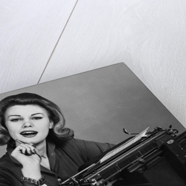 1960s smiling secretary with a typewriter by Anonymous