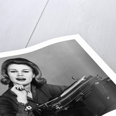 1960s smiling secretary with a typewriter by Anonymous
