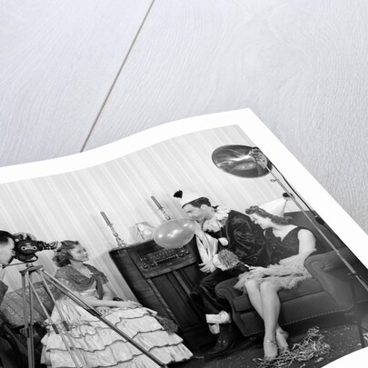 1940s photographer taking picture of young people at New Years party by Anonymous