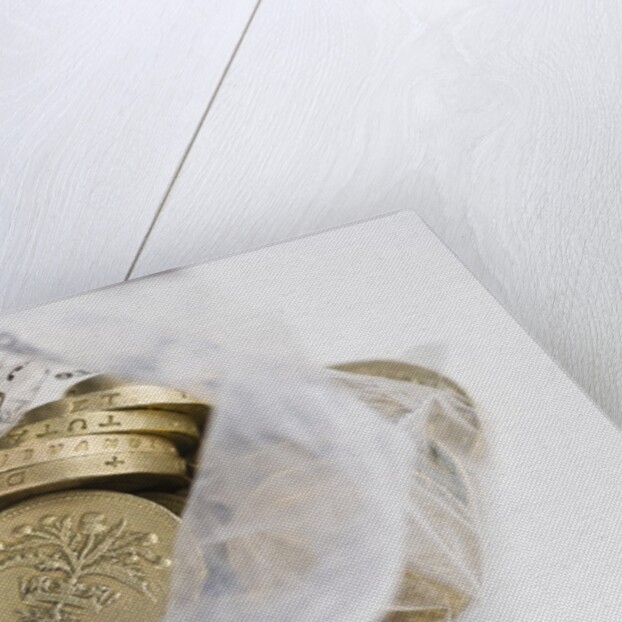 Looking down into an open money bag of pound coins by Anonymous