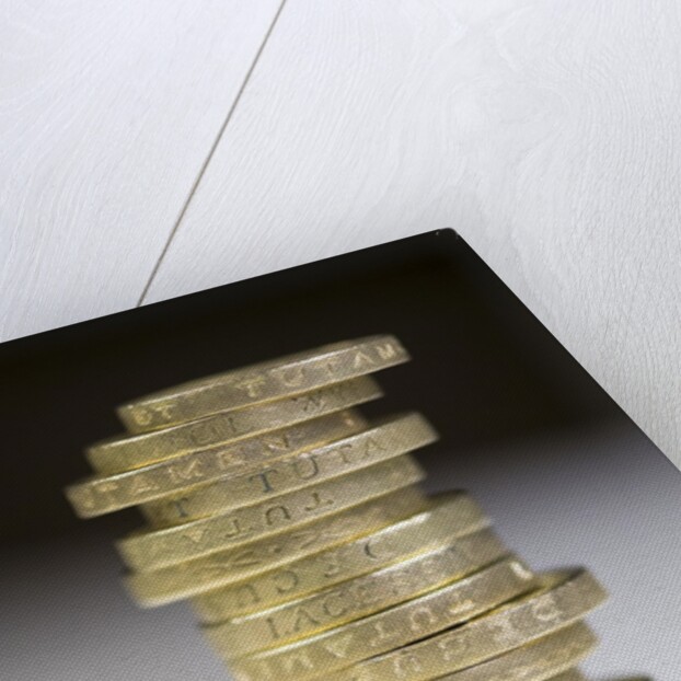 A pile of pound coins on a table by Anonymous