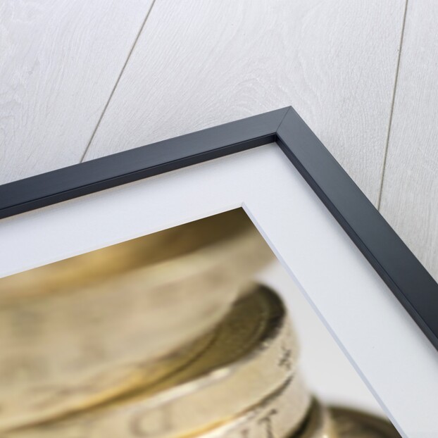 A pile of pound coins on a table by Anonymous