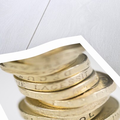 A pile of pound coins on a table by Anonymous