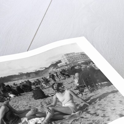 1920s two women sitting on the beach in bathing suits by Anonymous