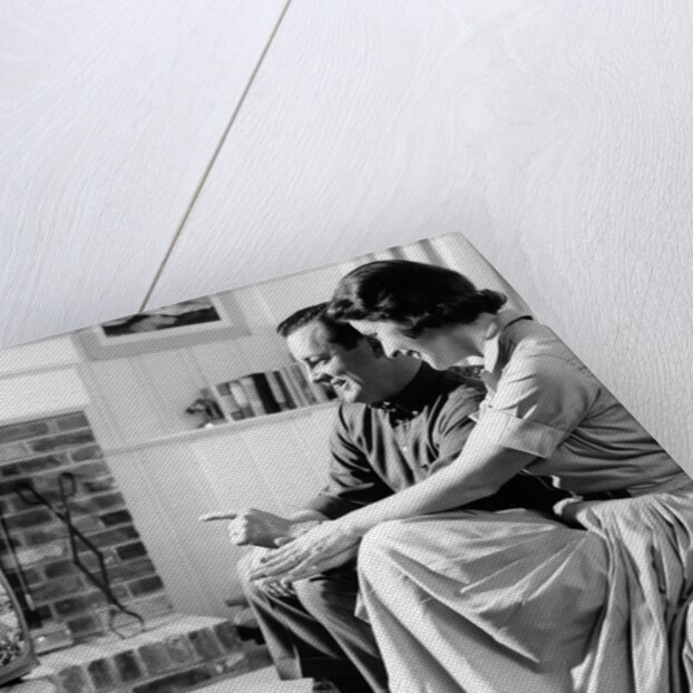 1950s couple watching television by Anonymous