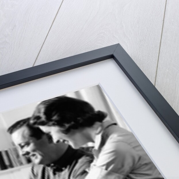 1950s couple watching television by Anonymous