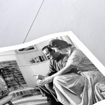 1950s couple watching television by Anonymous