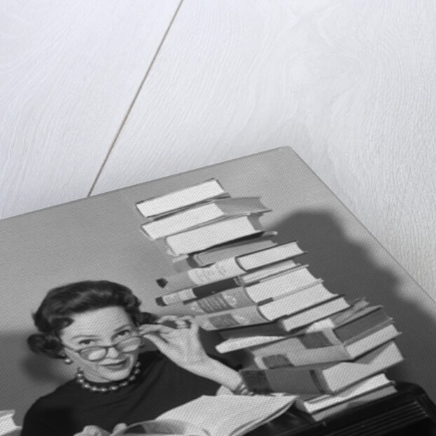 1950s portrait of woman sitting with stacks of books by Anonymous