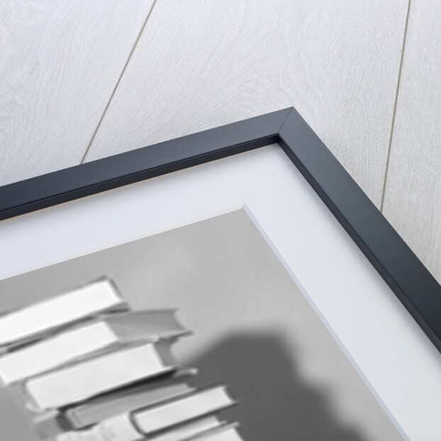 1950s portrait of woman sitting with stacks of books by Anonymous