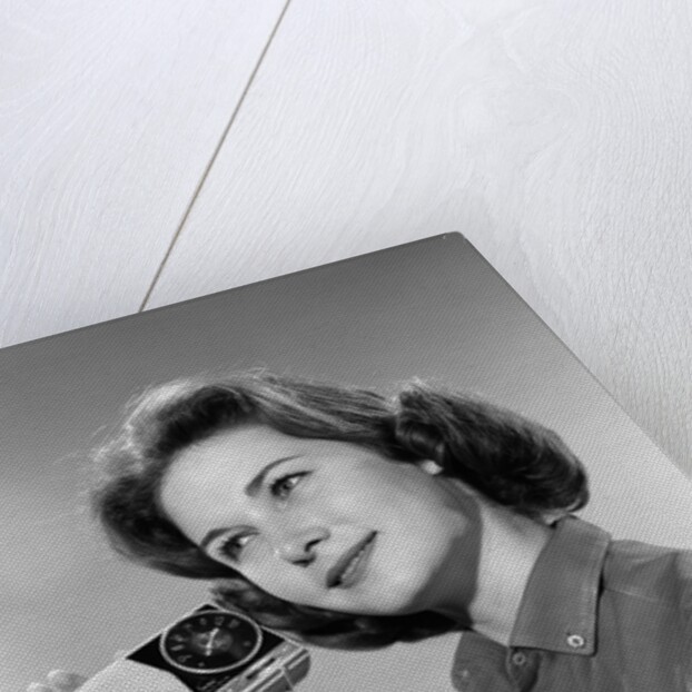1960s smiling teenage girl listening to portable radio by Anonymous