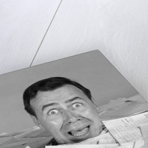 1960s portrait of bug-eyed man buried by bills by Anonymous