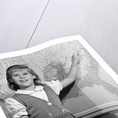 1960s school girl pointing to map of the USA by Anonymous