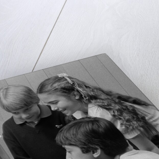 1980s boys and girl playing games on a computer by Anonymous
