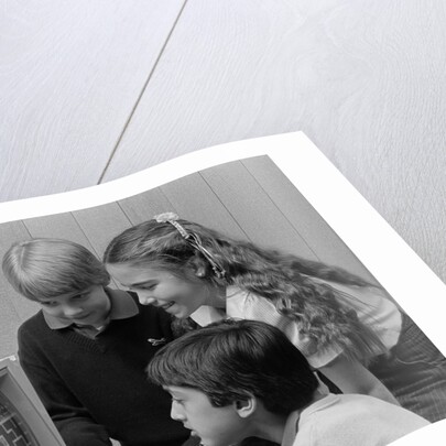 1980s boys and girl playing games on a computer by Anonymous