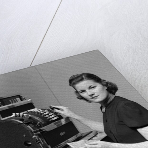 1930s 1940s portrait of female sales clerk at a cash register by Anonymous