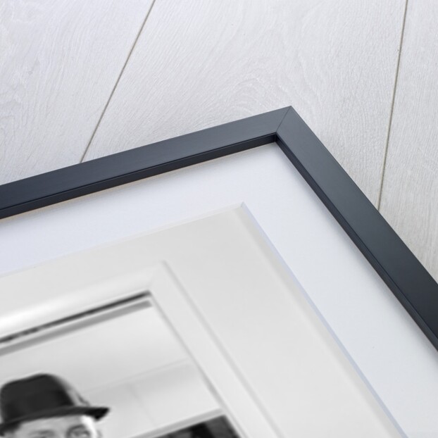 1960s family standing in doorway wearing winter coats and holding Christmas presents by Anonymous