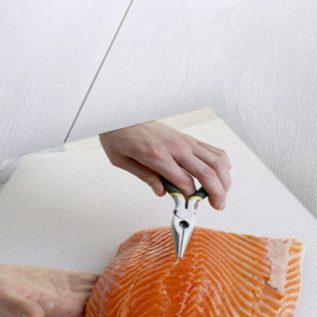 Deboning a salmon fillet by Anonymous