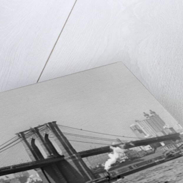 The Brooklyn Bridge spans the East River, ca. 1910. by Anonymous