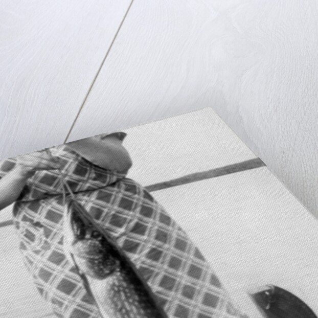 Woman holds on large Northern Pike on a lake pier, ca. 1950. by Anonymous