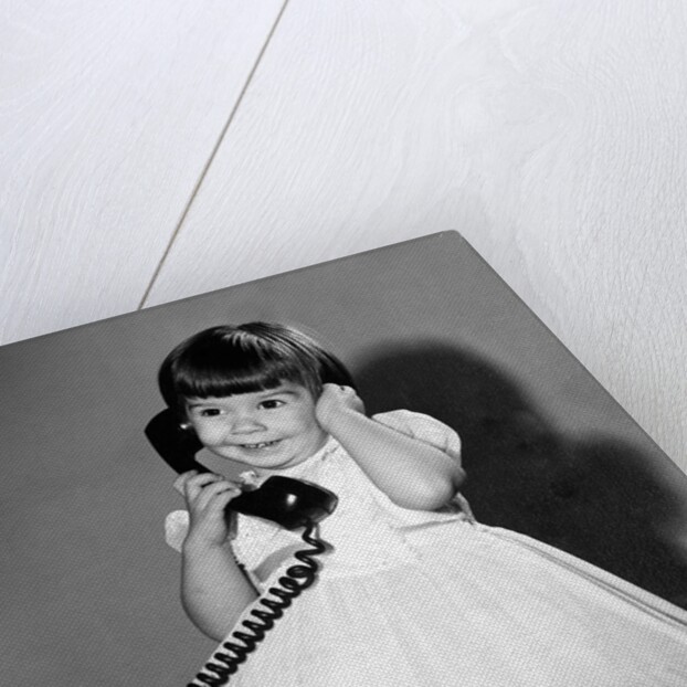 Young girl talks on the phone, ca. 1962. by Anonymous