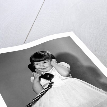 Young girl talks on the phone, ca. 1962. by Anonymous