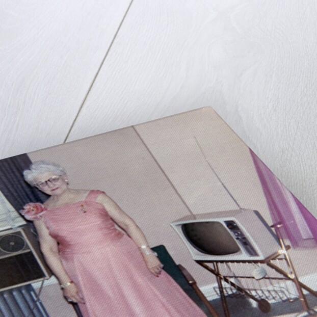 Grandma is all dressed up and standing next to a TV, ca. 1965 by Anonymous