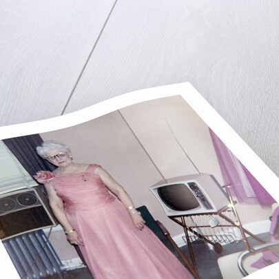 Grandma is all dressed up and standing next to a TV, ca. 1965 by Anonymous