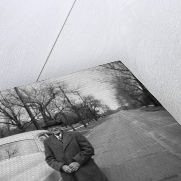 Senior man with his automobile on an Illinois street, ca. 1950. by Anonymous