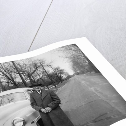 Senior man with his automobile on an Illinois street, ca. 1950. by Anonymous