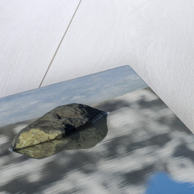 Rock with sky reflected in water. by Anonymous