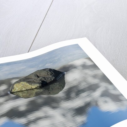 Rock with sky reflected in water. by Anonymous