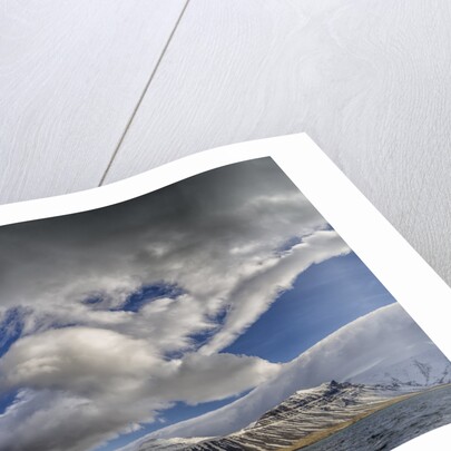 Clouds over fjord in the winter. by Anonymous