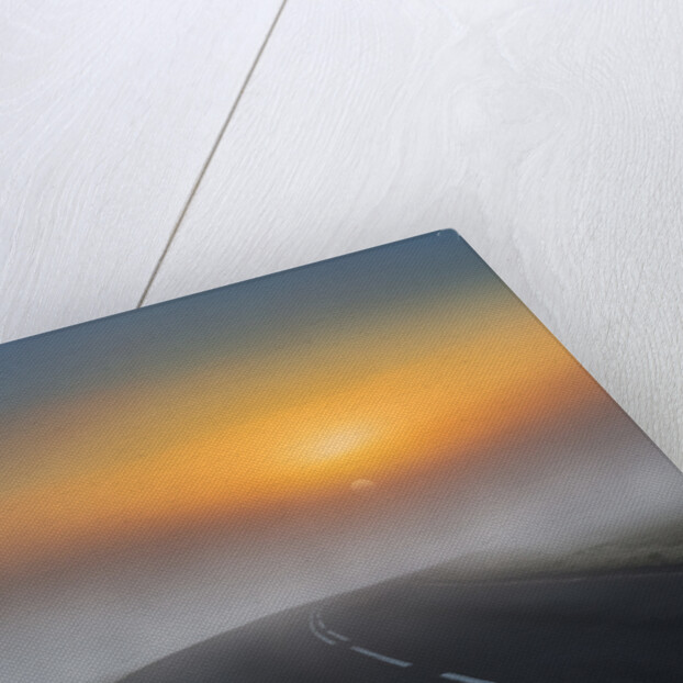 Empty road with fog and sunset. by Anonymous