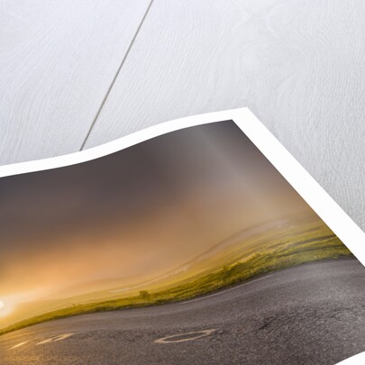 Empty road with fog and sunset. by Anonymous